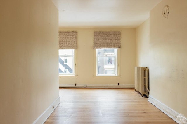 526-528 Warren St, Hudson, NY 12534 - unfurnished room with radiator heating unit, light wood-style flooring, and baseboards