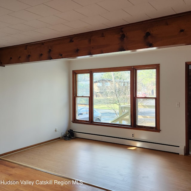 148 Lake Shore Dr, Copake, NY 12516 - spare room with a baseboard heating unit, healthy amount of natural light, and wood finished floors