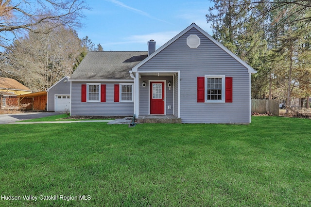 view of front of home with fence, roof with shingles, driveway, a chimney, and a front lawn