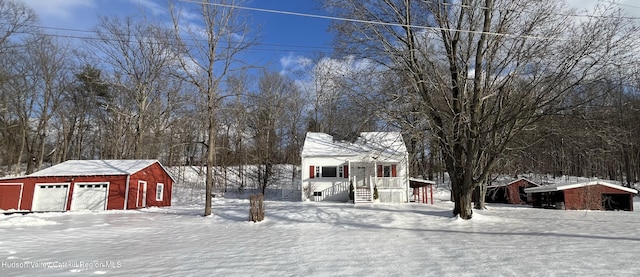 view of front of property with a garage and an outbuilding