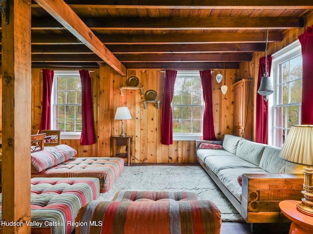 interior space featuring beam ceiling, wood ceiling, and wood walls