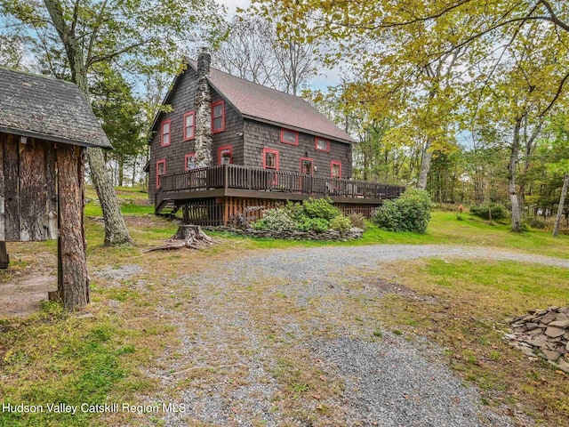 view of property exterior featuring a deck