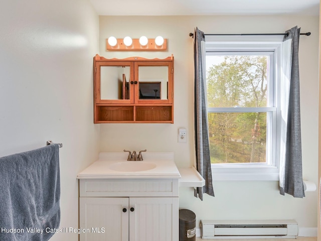 bathroom featuring plenty of natural light, vanity, and a baseboard radiator