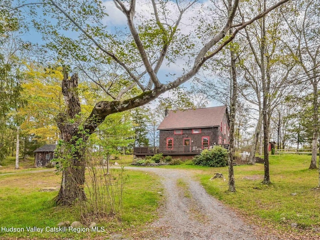 view of front of home featuring a wooden deck and a front lawn