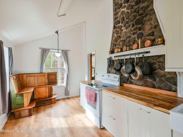 kitchen featuring white cabinetry, white range with electric cooktop, pendant lighting, lofted ceiling, and light wood-type flooring