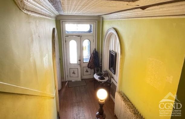 22 Liberty St, Catskill, NY 12414 - doorway to outside with radiator heating unit and wood finished floors