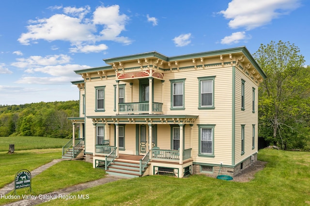 279 Maybie Rd, Gilboa, NY 12076 - italianate home with a porch, a balcony, and a front lawn