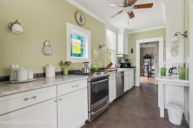 279 Maybie Rd, Gilboa, NY 12076 - kitchen featuring appliances with stainless steel finishes, ornamental molding, ceiling fan, white cabinetry, and light stone counters