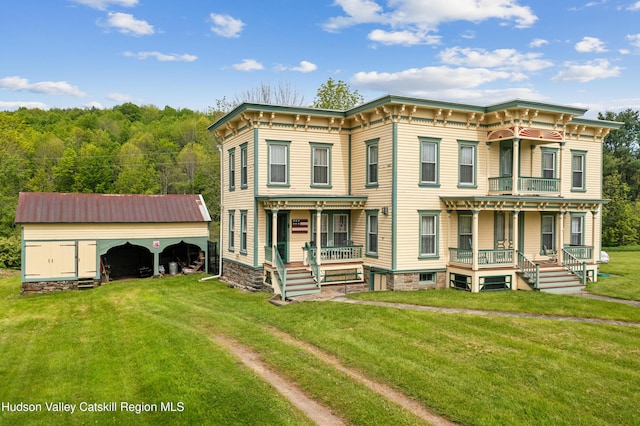 279 Maybie Rd, Gilboa, NY 12076 - italianate-style house with a porch, a front yard, and an outbuilding