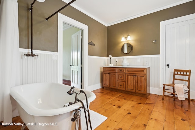 279 Maybie Rd, Gilboa, NY 12076 - full bath with a wainscoted wall, a freestanding bath, double vanity, hardwood / wood-style floors, and ornamental molding