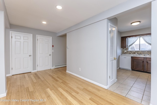 interior space featuring a baseboard heating unit, light hardwood / wood-style floors, and sink