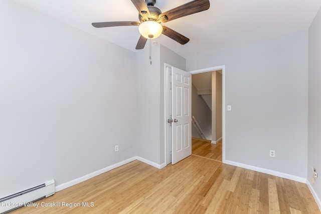 unfurnished bedroom with a baseboard radiator, ceiling fan, and light hardwood / wood-style flooring