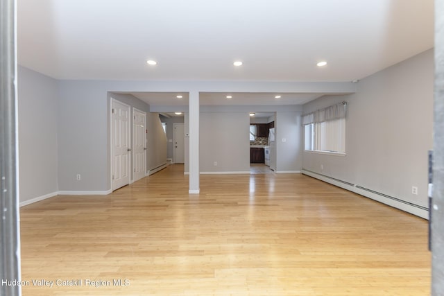 interior space featuring light wood-type flooring and baseboard heating