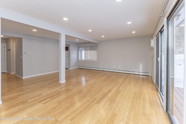 interior space with baseboard heating and light hardwood / wood-style flooring