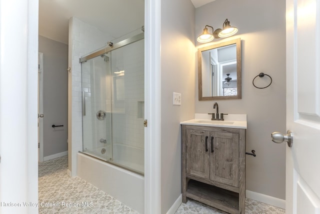 bathroom with vanity and bath / shower combo with glass door