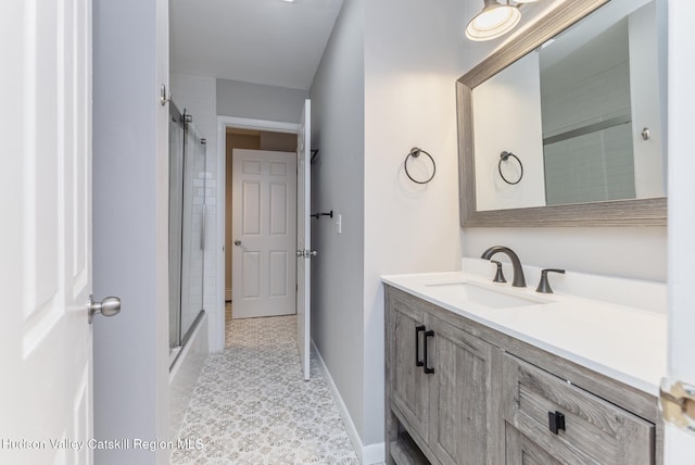 bathroom with vanity and enclosed tub / shower combo