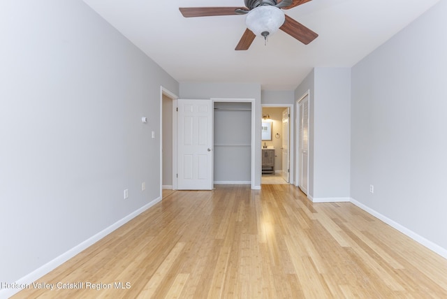 unfurnished bedroom with ceiling fan, connected bathroom, and light hardwood / wood-style floors