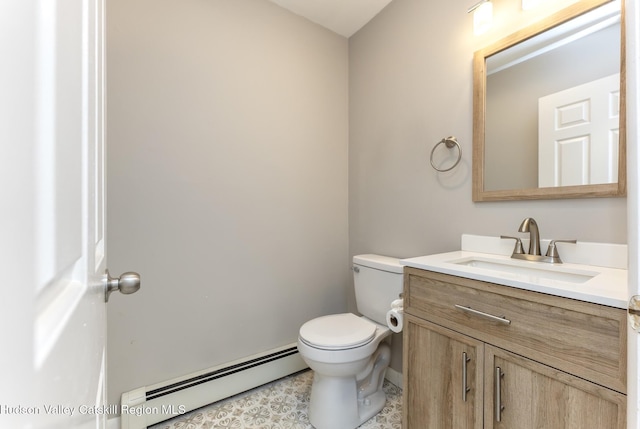 bathroom with vanity, a baseboard heating unit, and toilet