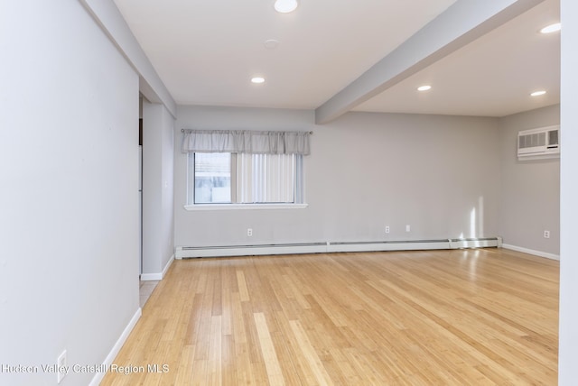 empty room featuring a baseboard radiator, beam ceiling, a wall mounted AC, and light hardwood / wood-style flooring