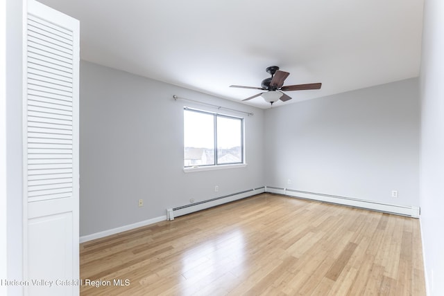 unfurnished room with baseboard heating, ceiling fan, and light wood-type flooring