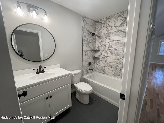 full bathroom featuring toilet, vanity, wood-type flooring, and tiled shower / bath