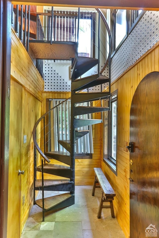 181 Mountain Dr, Hunter, NY 12442 - stairs featuring wood walls, a high ceiling, and stone finish flooring