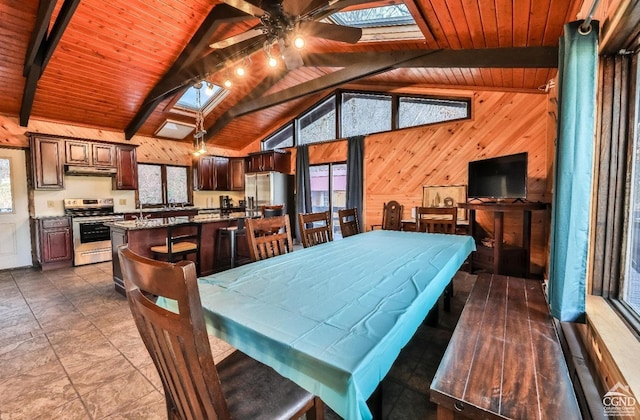 181 Mountain Dr, Hunter, NY 12442 - dining area featuring a skylight, wooden walls, ceiling fan, and wooden ceiling