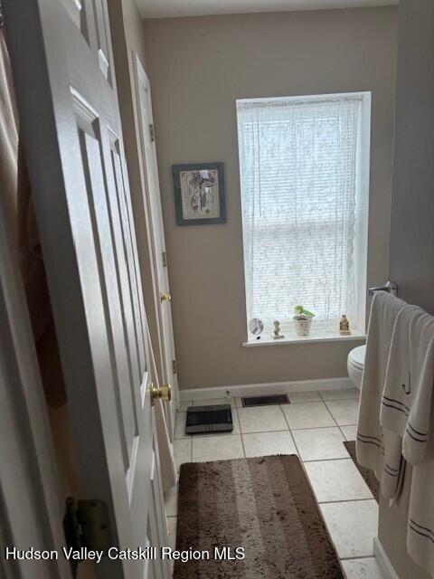 bathroom featuring tile patterned flooring and toilet