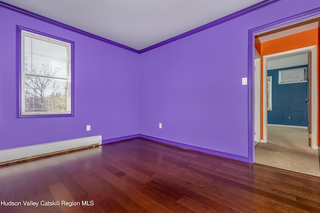 empty room featuring crown molding, wood finished floors, baseboards, and a baseboard radiator