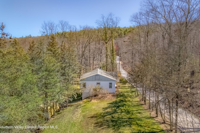 birds eye view of property with a forest view