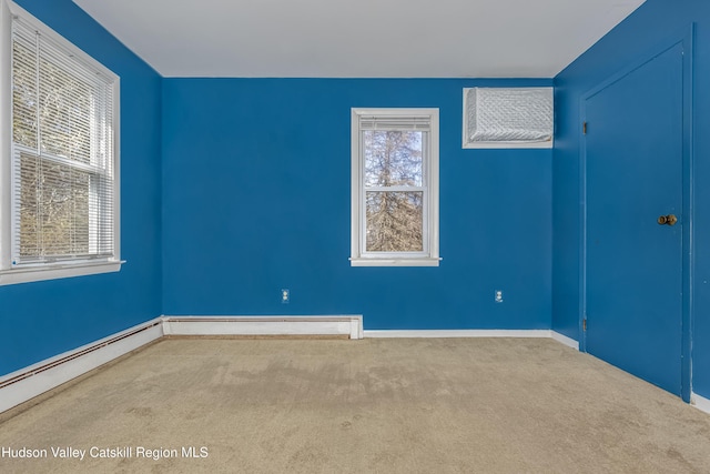 carpeted spare room featuring baseboards and a baseboard radiator