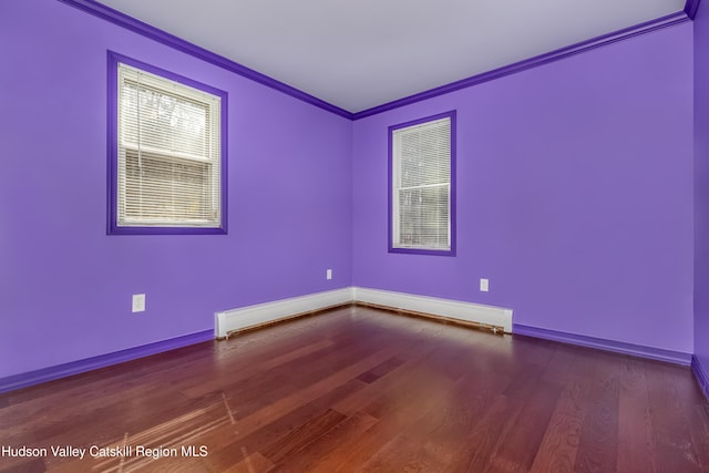 spare room with wood finished floors, baseboards, a baseboard radiator, and ornamental molding