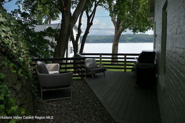 wooden deck featuring a water view