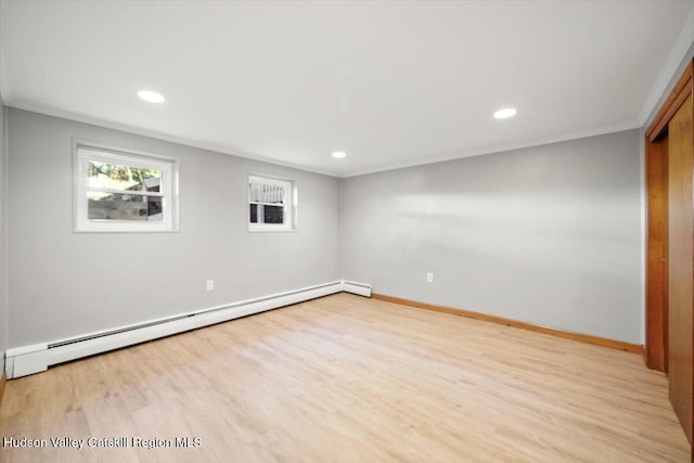 unfurnished room with baseboard heating, light hardwood / wood-style floors, and ornamental molding