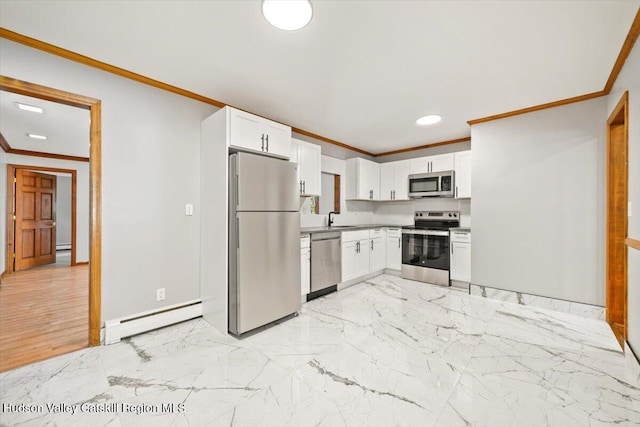 kitchen featuring baseboard heating, white cabinetry, crown molding, and stainless steel appliances