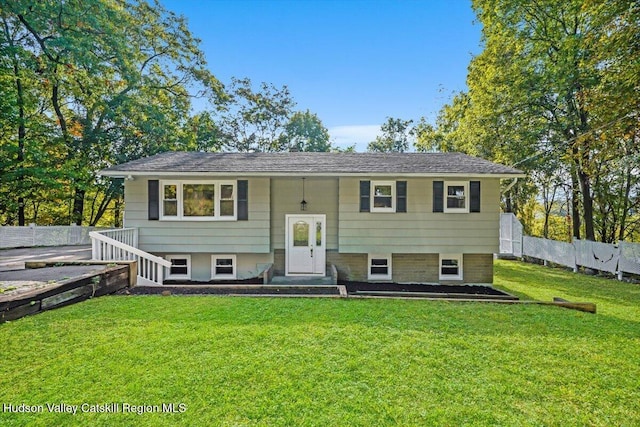 raised ranch with a front yard