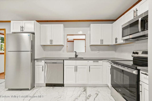 kitchen with white cabinets, backsplash, sink, and stainless steel appliances