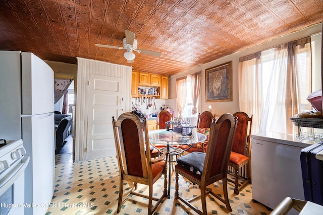 dining space with an ornate ceiling and ceiling fan