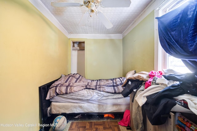 bedroom featuring ceiling fan, ornamental molding, and a closet