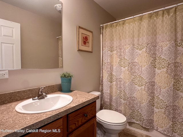 bathroom featuring vanity, a shower with shower curtain, tile patterned flooring, and toilet