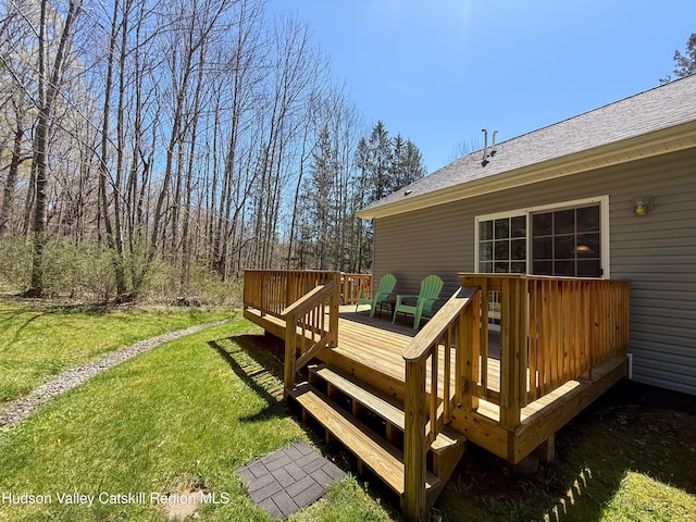 wooden deck with a lawn