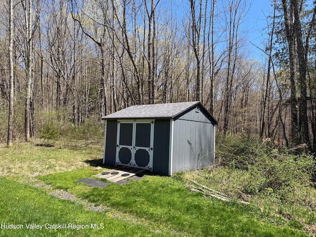 view of shed featuring a forest view