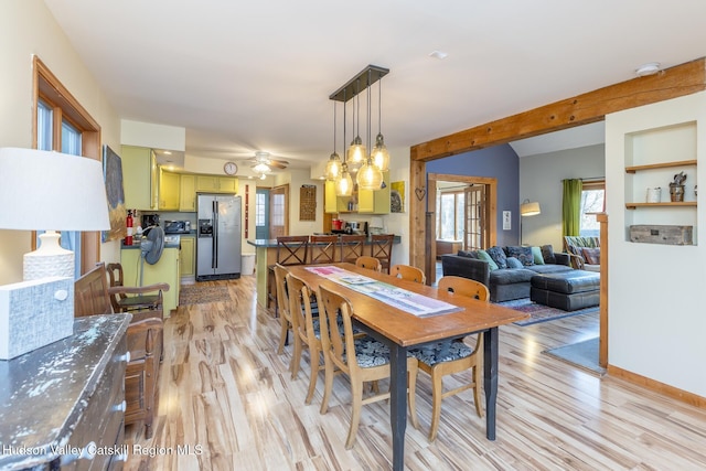 dining space with ceiling fan and light hardwood / wood-style floors