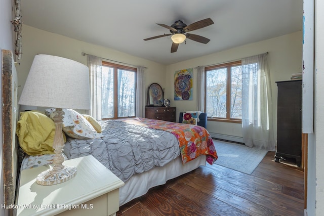 bedroom with dark hardwood / wood-style floors, multiple windows, and ceiling fan