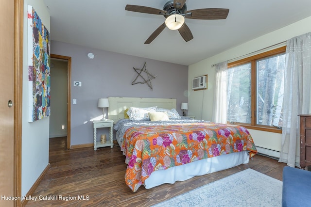 bedroom with baseboard heating, ceiling fan, a wall unit AC, and dark hardwood / wood-style floors