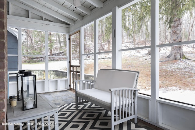 sunroom featuring wood ceiling and lofted ceiling with beams