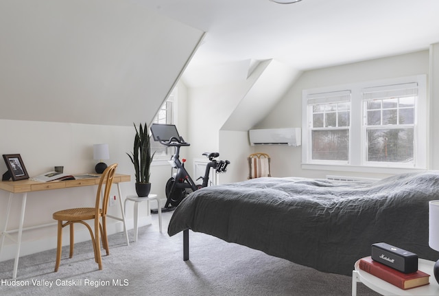 carpeted bedroom with a wall mounted AC and vaulted ceiling