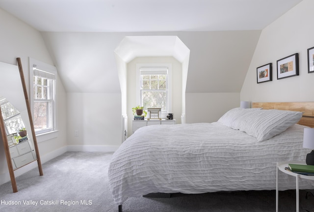 carpeted bedroom with lofted ceiling