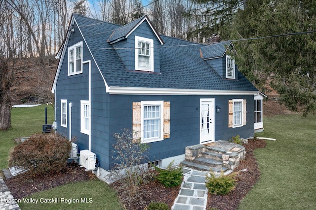 cape cod house with a front lawn