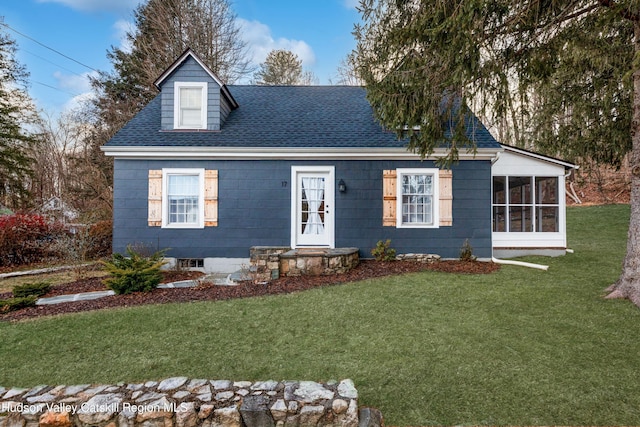 view of front of home with a front lawn and a sunroom